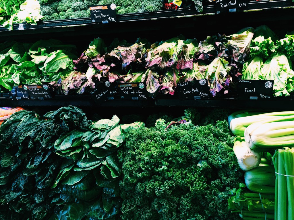 Produce shelf full of lettuce, chard, kale and other greens