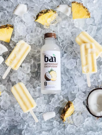 Pina Colada Popsicles around ice, coconut, and pineapple with Bai Molokai Coconut