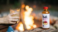 Smokey campfire cocktail by a campfire with Bai Malawi Mango