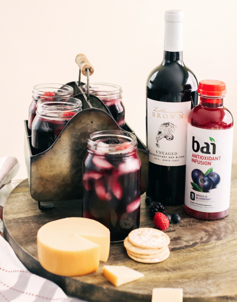 Cheese, crackers, and a drink made with Bai Brasilia Blueberry and Z. Alexander Brown Proprietary Red Blend wine