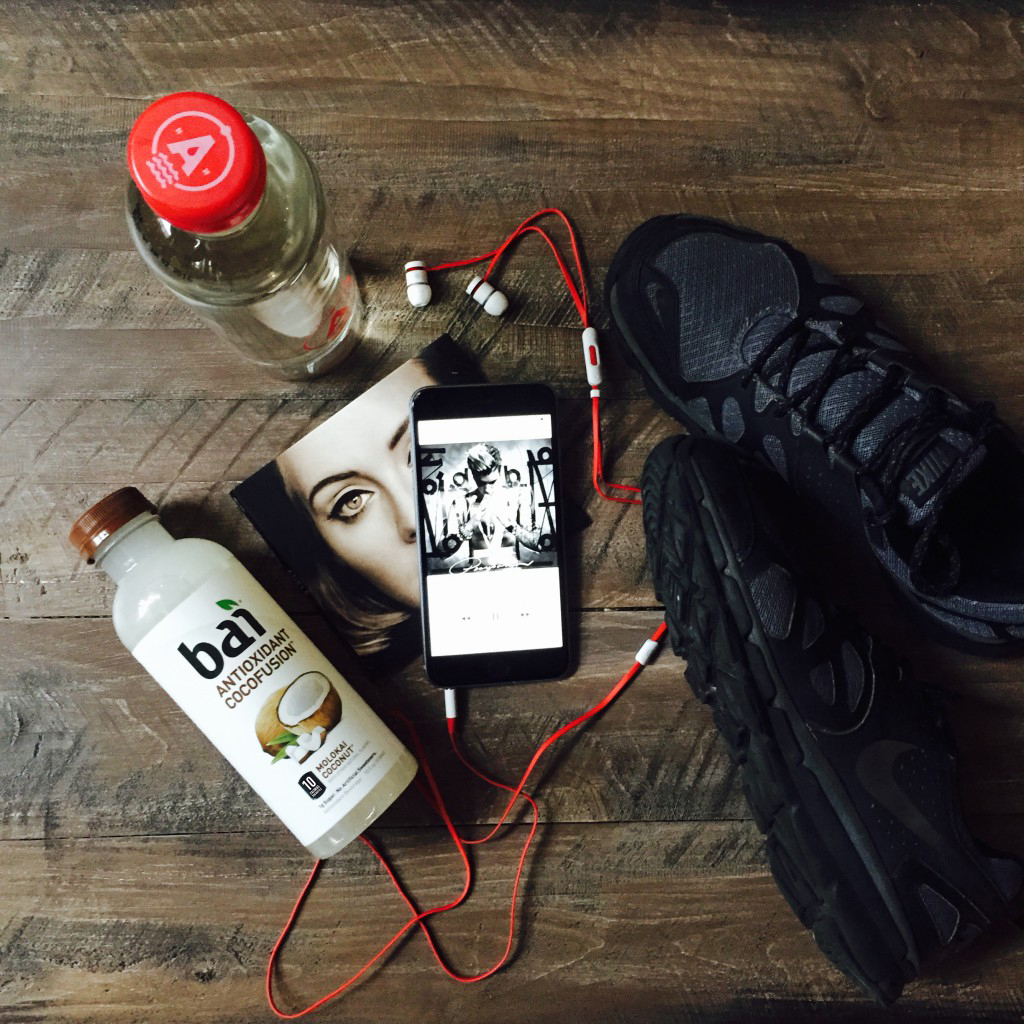 Workout shoes, headphones, music on a phone, and Bai Molokai Coconut