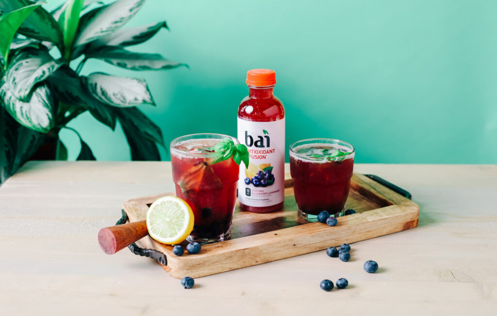 Blueberry Basil Bourbon Smash cocktail made with Brasilia Blueberry Bai