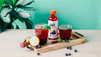 Blueberry Basil Bourbon Smash cocktail made with Brasilia Blueberry Bai