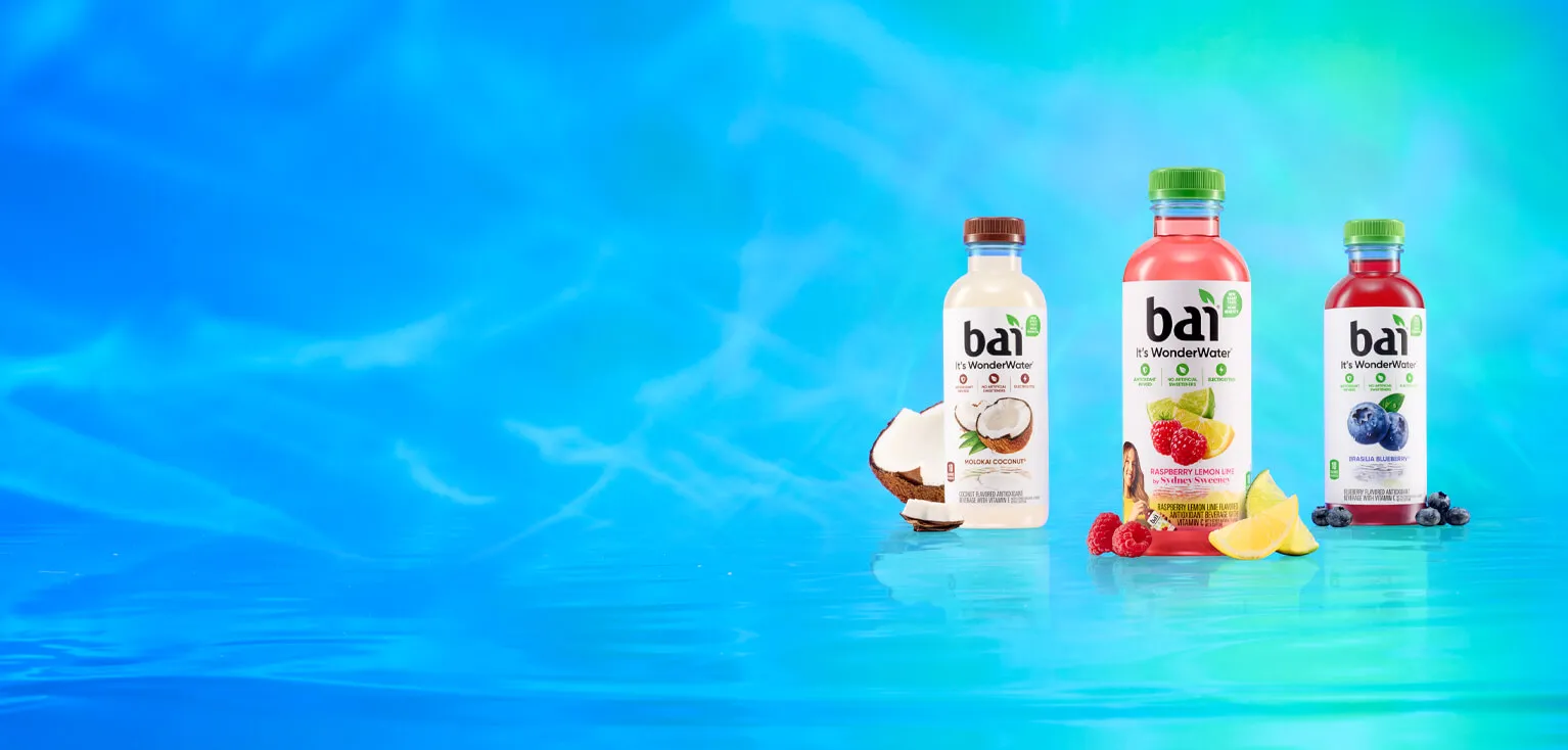 Bai Bottles next to fruit showcasing their respective flavors